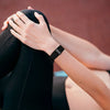 Person stretching with a Hume longevity tracker on wrist