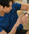Person wearing a blue shirt using a smartwatch
